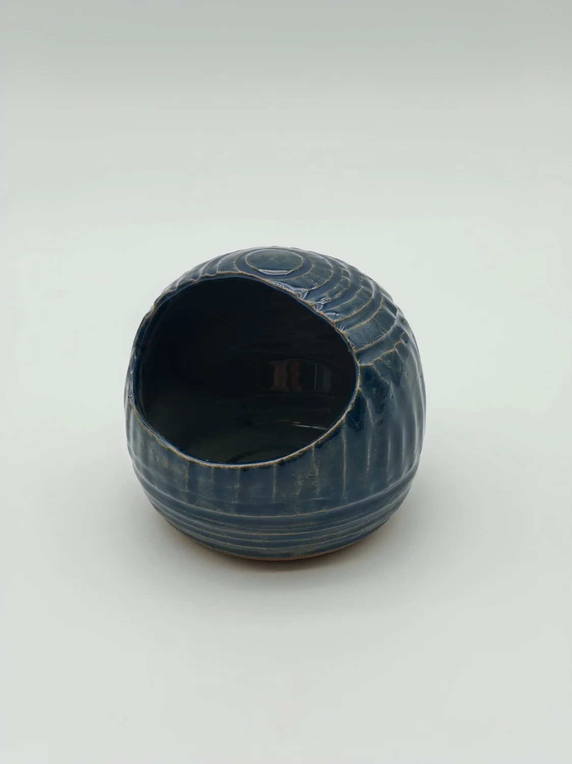 Blue salt dish with a rounded opening and carved vertical lines