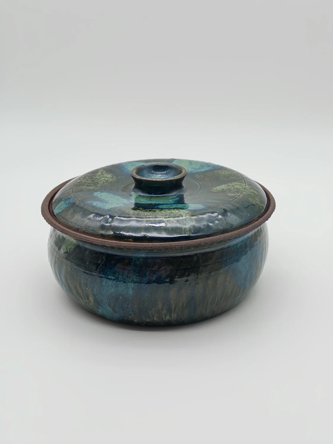 Blue and green lidded jar with a patterned interior, view 2