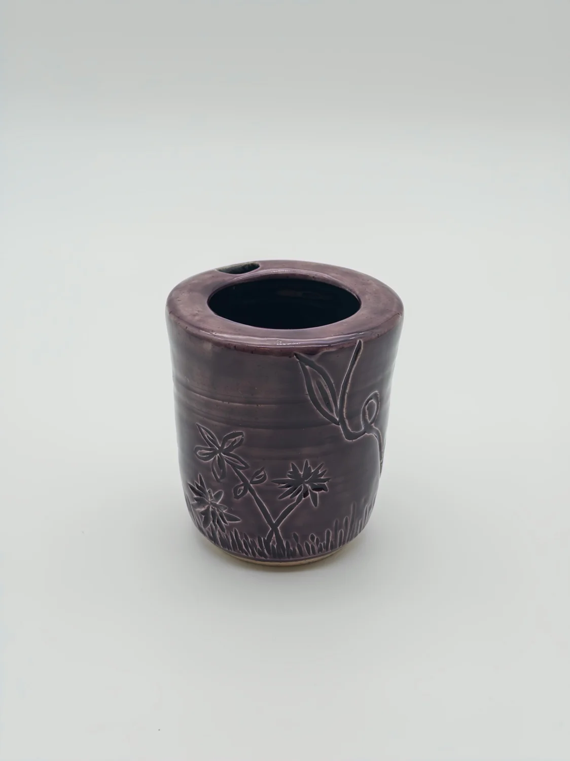 Purple travel cup with carved flowers and a sipping opening, view 2